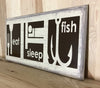 Eat sleep fish wood sign for cabin or man cave decor.