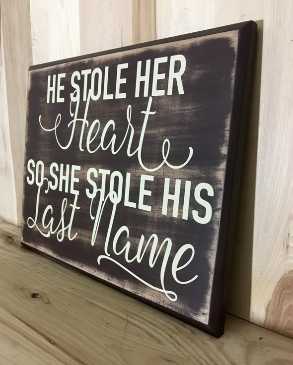 He stoler her heart, so she stole his last name wood sign makes great wedding gifts.