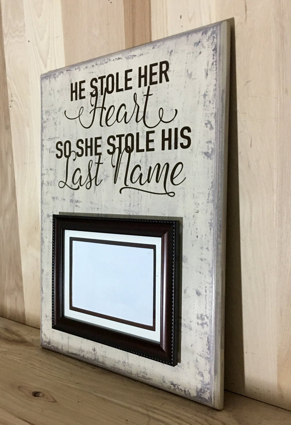 He stole her heart, so she stole his last name wood sign with attached picture frame.
