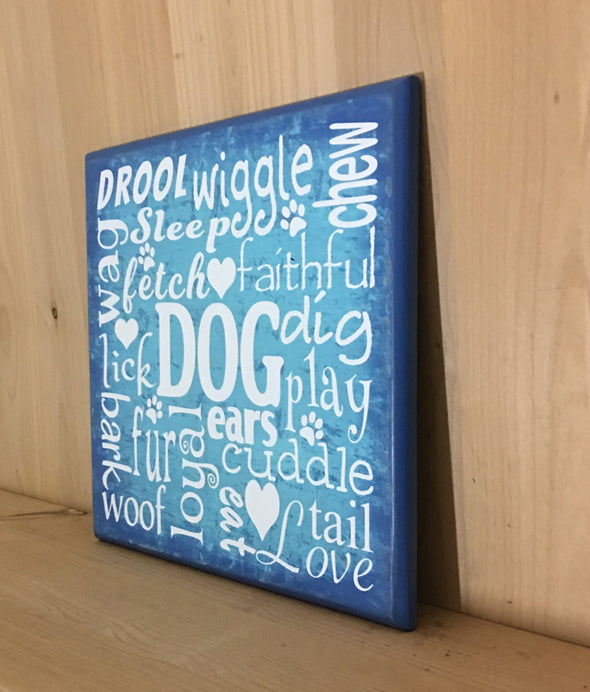 Wooden sign with dog words in subway art style.