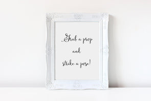Grab a prop and strike a pose wedding sign.