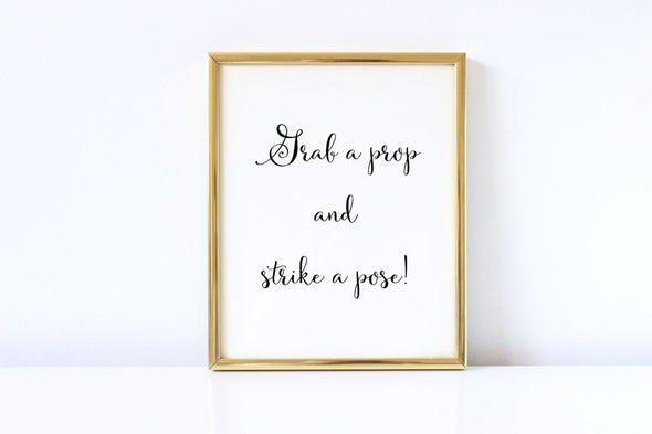 Grab a prop and strike a pose wedding sign.