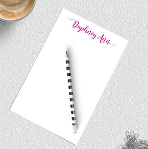 Personalized notepad with calligraphy flourish.