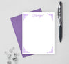 Decorative personalized stationery set with purple envelope.
