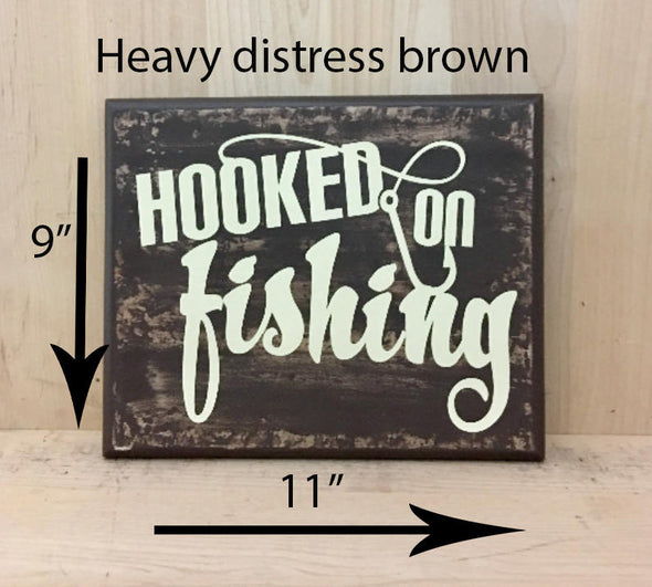 9x11 heavy distress brown fishing wood sign with cream lettering.