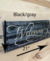 8x21 black/gray welcome wood sign with white lettering.