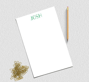 Personalized printed notepad in green ink.