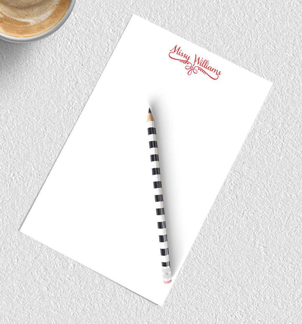 Decorative personalized notepad with red ink.
