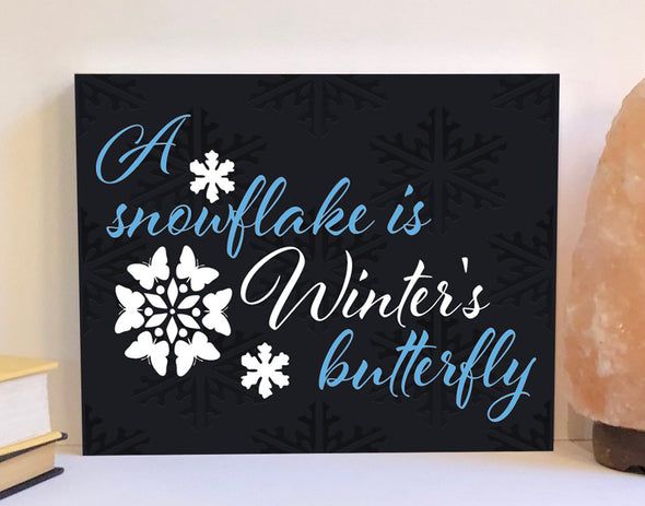A snowflake is winter's butterfly wood sign