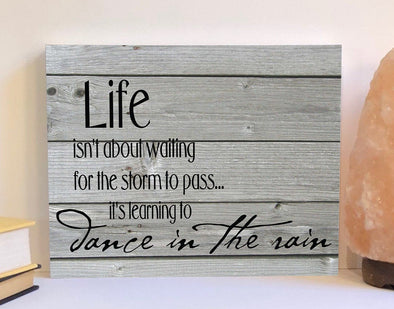 Life isn't about waiting for the storm to pass wood sign