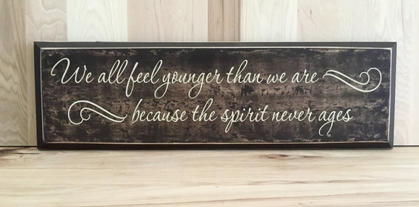 We all feel younger wood sign with saying