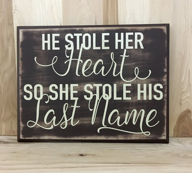 He stoler her heart, so she stole his last name wood sign.