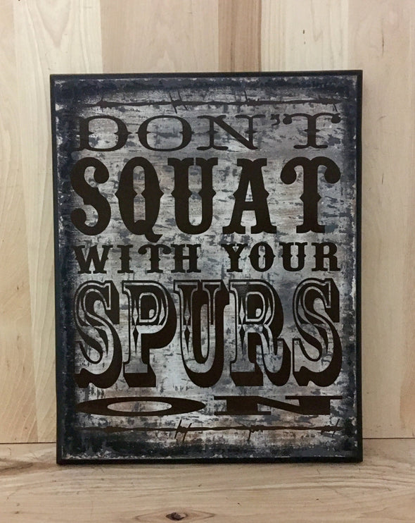 Don't squat with your spurs on western wood sign.