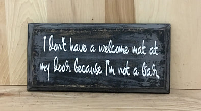 I don't have a welcome mat at my door because I'm not a liar wood sign.