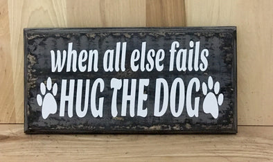 When all else fails hug the dog wooden sign.