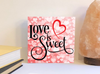 Love is sweet Valentine's Day sign.